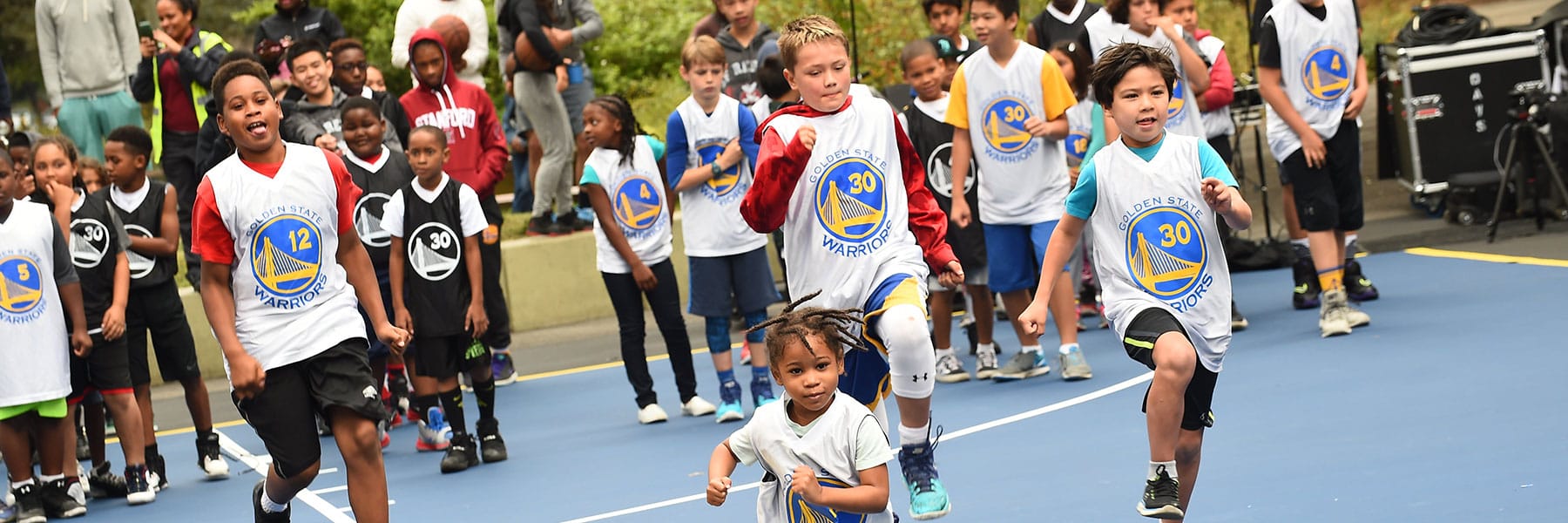Kids running on a basketball court