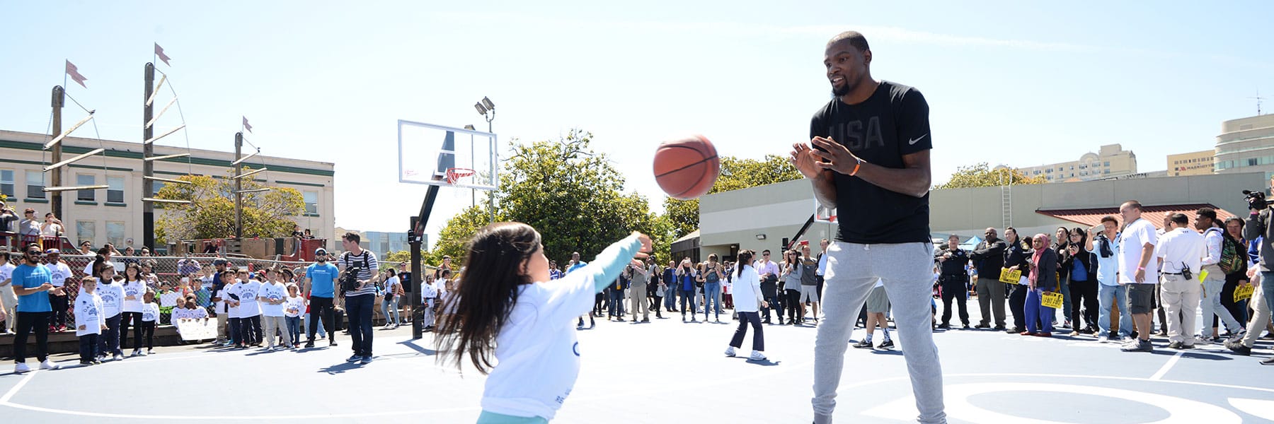 Girl playing basketball with basketball player