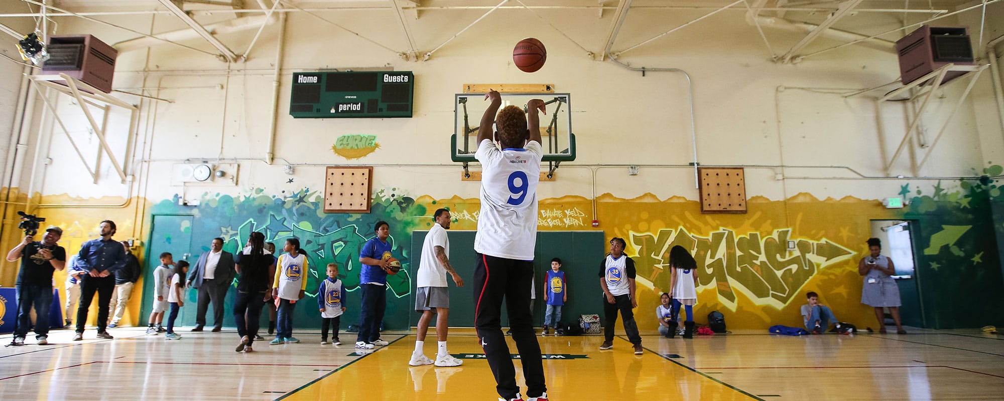 Child shooting a basketball in a court