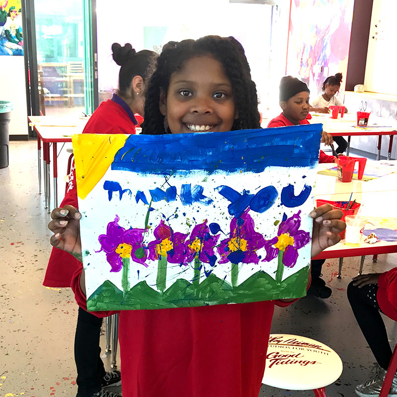 Little girl showing her painting
