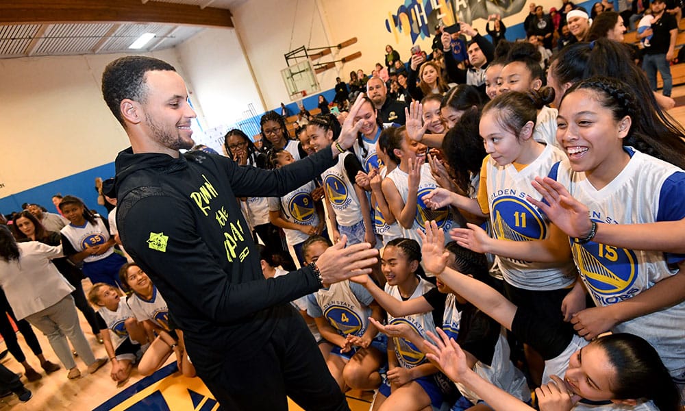 teph Curry, Point Guard for the Golden State Warriors High Fiving Girls Basketball Team